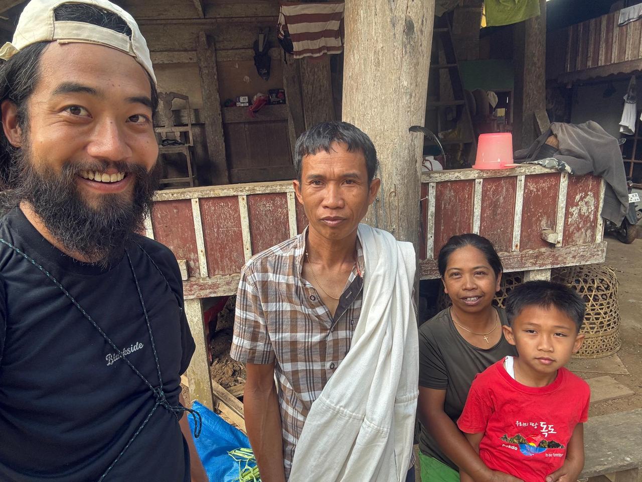 A farewell photo with a former host family, including a mother, father, and their young son