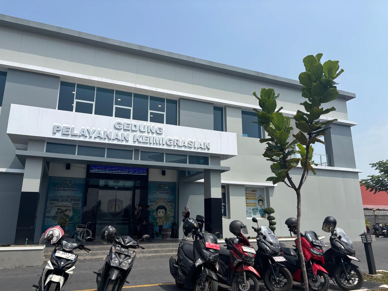 The exterior of the immigration services building in Palopo with motorbikes parked out front