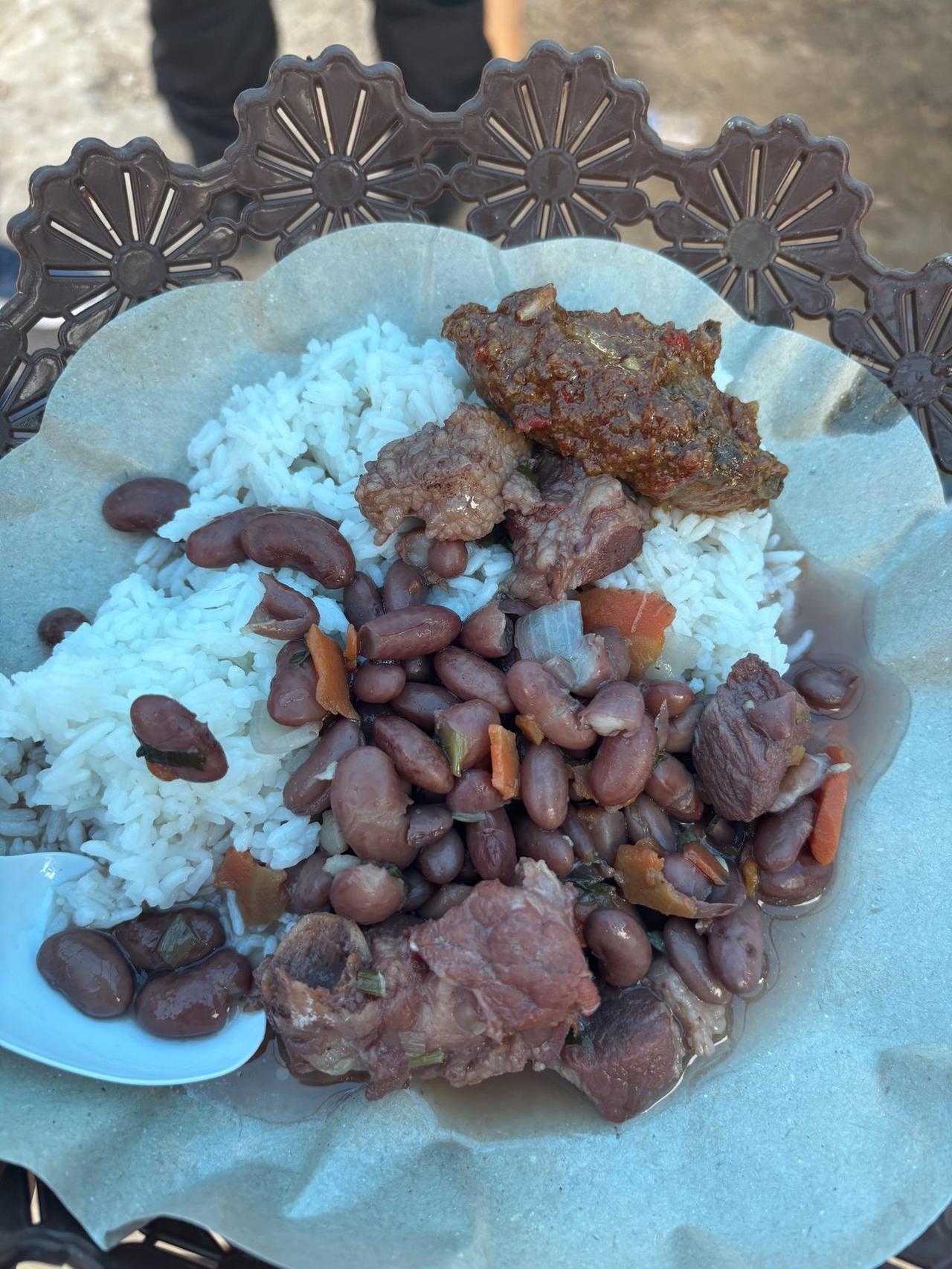 A plate of rice, stewed red kidney beans, and meat served at Festival Marawai in Hatalai village.